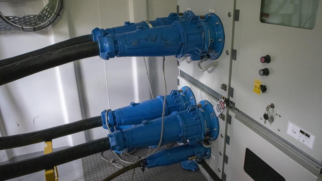 Two large electrical plugs plugged into a cruise ship called shore power