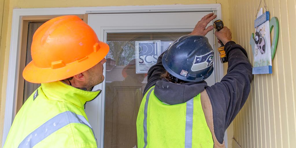 Two noise rememdiation specialists work on a Burien area home, April 2019