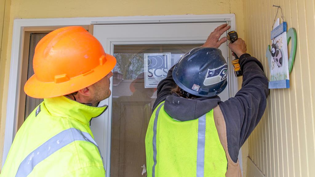 Two noise rememdiation specialists work on a Burien area home, April 2019