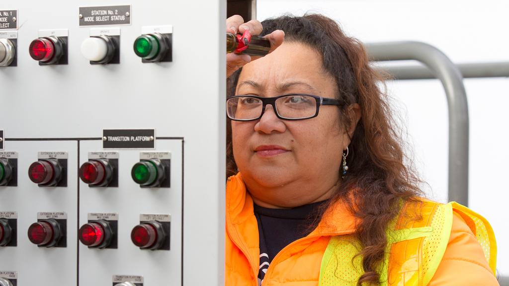 Shannon Neal works on an electrical panel, Feb. 2015, Seattle