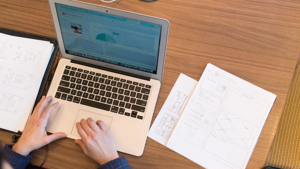 Laptops with person typing notes